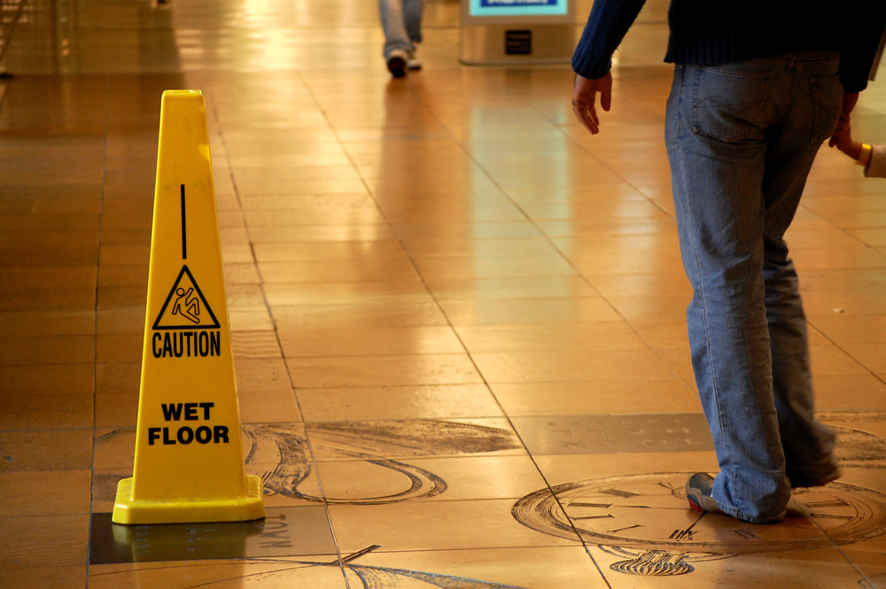 slip and fall lawyer - Caution Wet Floor sign in a shopping mall