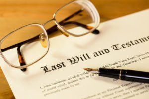 2 Key Will Exclusions - Last will and testament with pen and glasses concept for legal d